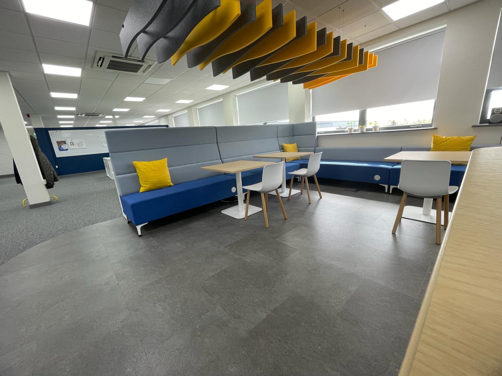 Agile working and breakout area at card factory wakefield with blue booth seating, yellow cushions, acoustic baffles and lvt flooring