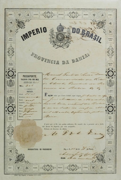 Documento intitulado Passaporte de Escravizado, pertencente ao Arquivo Público do Estado da Bahia. O documento foi emitido em 1865 e apresenta validade de um mês. Impresso em papel de tom amarelado pelo tempo, traz ao centro o brasão do Império do Brasil encimado por uma coroa, com a inscrição “Império do Brasil” em destaque. A maior parte do documento é preenchida à mão com tinta escura. À esquerda, há um quadro com informações de identificação da pessoa escravizada, incluindo idade, estatura, rosto, cabelos, olhos, nariz, boca, cor e barba. Na parte inferior, aparecem o espaço para a assinatura do passageiro, uma marca de selo em papel e assinaturas das autoridades responsáveis. Toda a página é contornada por uma moldura decorativa que reúne os nomes das províncias do Império. O documento evidencia o controle exercido pelo Estado sobre a circulação de pessoas escravizadas no Brasil durante o período imperial.