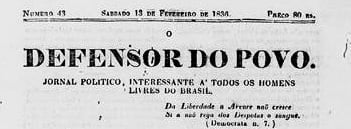 Recorte da parte superior da edição nº 43 do jornal O Defensor do Povo, disponível na BNDigital. O documento é impresso em papel claro com texto em tinta preta. Na faixa superior aparecem a identificação da edição, a data sábado, 13 de fevereiro de 1836, o número da publicação e o preço. Ao centro, em letras grandes e em negrito, está o título “O Defensor do Povo”. Logo abaixo, lê-se a descrição “Jornal Político, Interessante a Todos os Homens Livres do Brasil”. À direita, há um trecho em destaque com a frase “A Liberdade é a árvore mais crescida da raiz que Deus plantou”, seguida da referência ao autor da citação. O recorte evidencia a apresentação gráfica do cabeçalho e a identidade editorial da publicação.