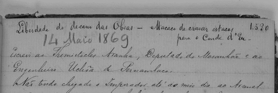 A imagem é um recorte de uma página do diário manuscrito de André Rebouças, datado de 14 de maio de 1869, parte do acervo da Fundação Joaquim Nabuco. No topo, em letra cursiva, está escrito 'Liberdade do decano das Obras - Macros de cenas etéreas para o Conde d'Eu'. A data '14 Maio 1869' está centralizada e destacada, escrita em um estilo ligeiramente maior e mais escuro. Abaixo, o texto continua com uma escrita cursiva e detalhada, mencionando autoridades da época, como o Ministro Amaro, Deputado do Maranhão, e o Engenheiro Uclésio de Pernambuco.