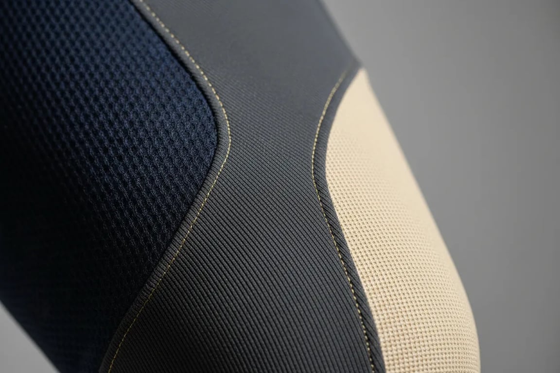 Close-up detail of multi-fabric zoning in custom riding breeches showing fabric transitions