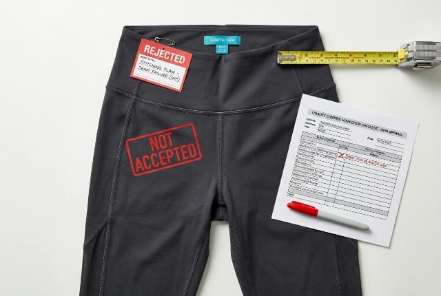 Reverse-engineer sample lane: finished yoga apparel garment flat-lay marked as not accepted