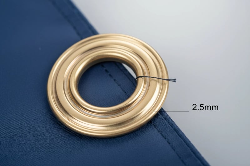 Thick brass grommet macro detail showing 2.5mm wall thickness, triple-layer anti-corrosion electroplating, mirror-polished surface finish, and precision-stamped edges preventing fabric tears on custom flags and banners