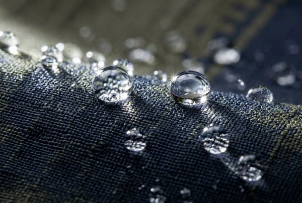 C6 DWR waterproof coating with water droplet rolling off fabric