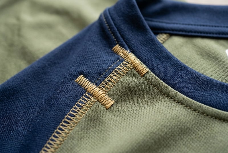 Reinforced stress point stitching on performance fishing garment