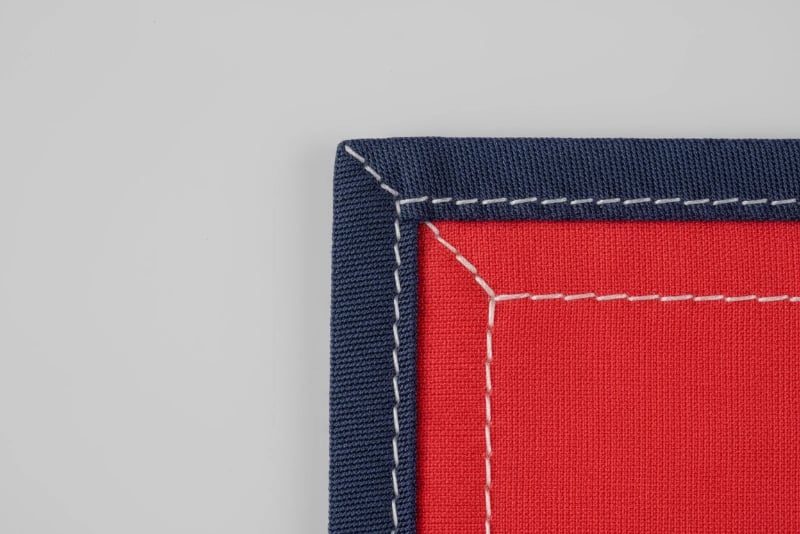 Square flag corner patches providing maximum coverage and protection for heavy-duty outdoor flags in high-wind environments with double-layer construction and heat-sealed edges