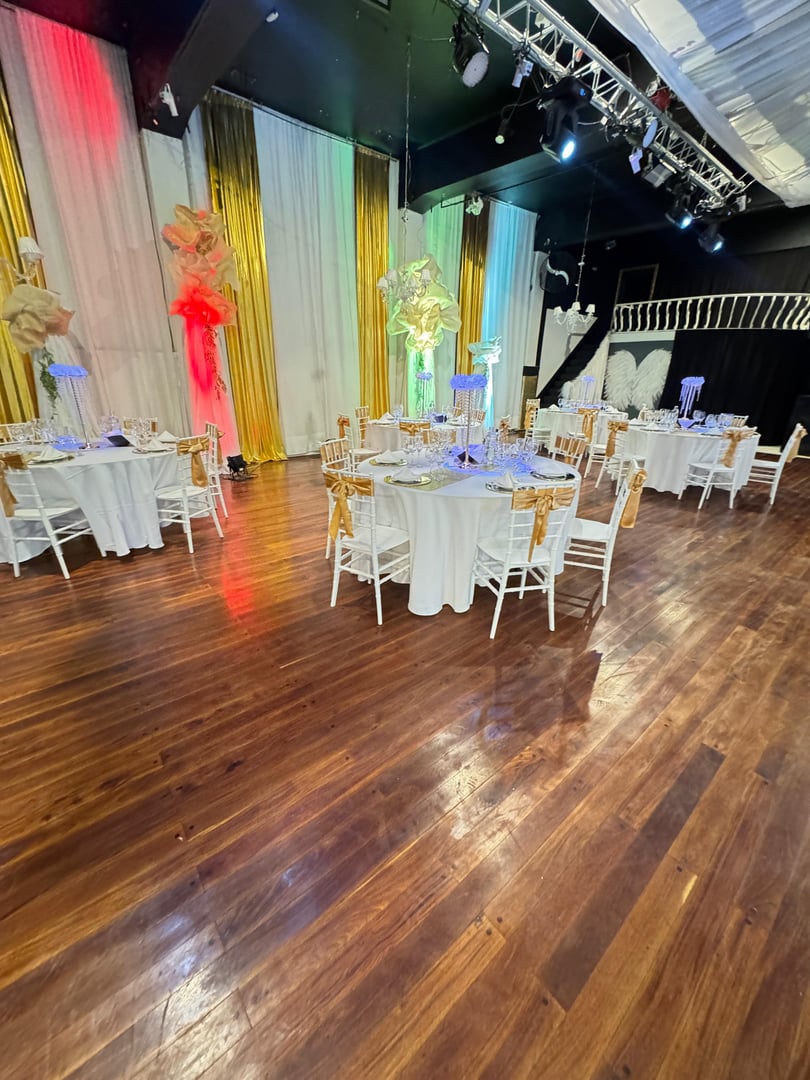 Salón Tarantino montado con mesas vestidas, techo entelado y piso de madera