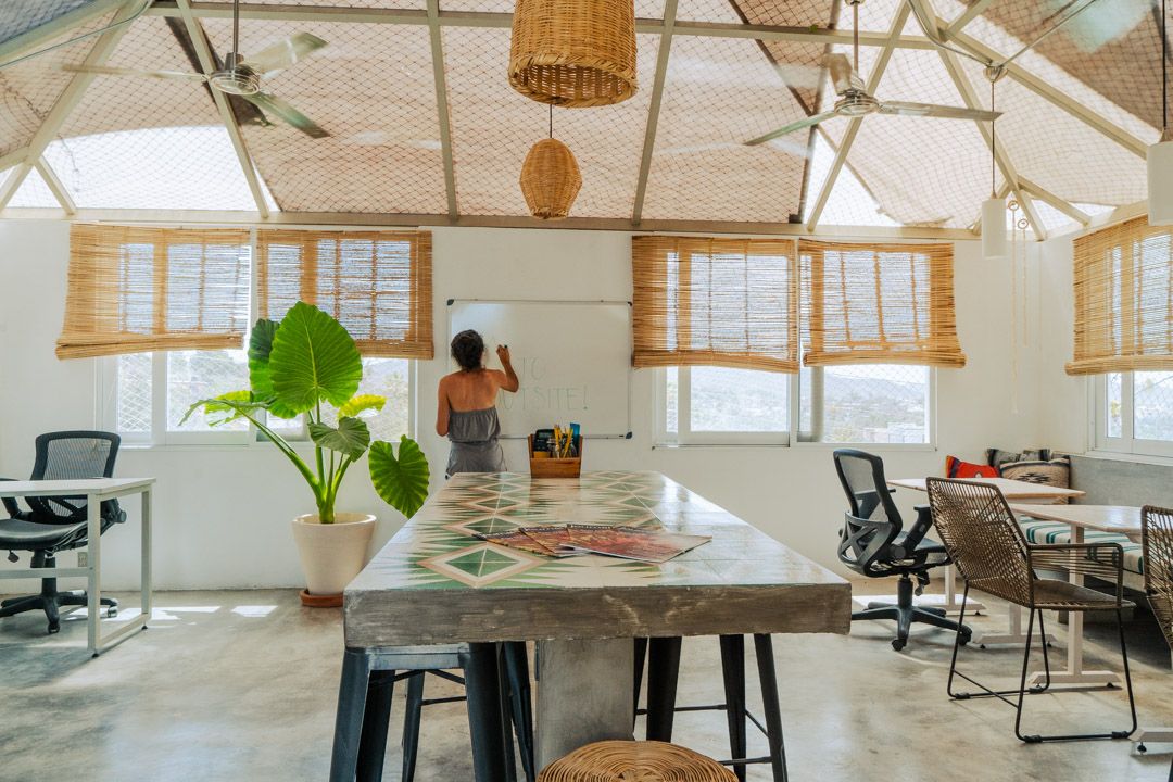 Coworking tables with ergonomic chairs and laptops