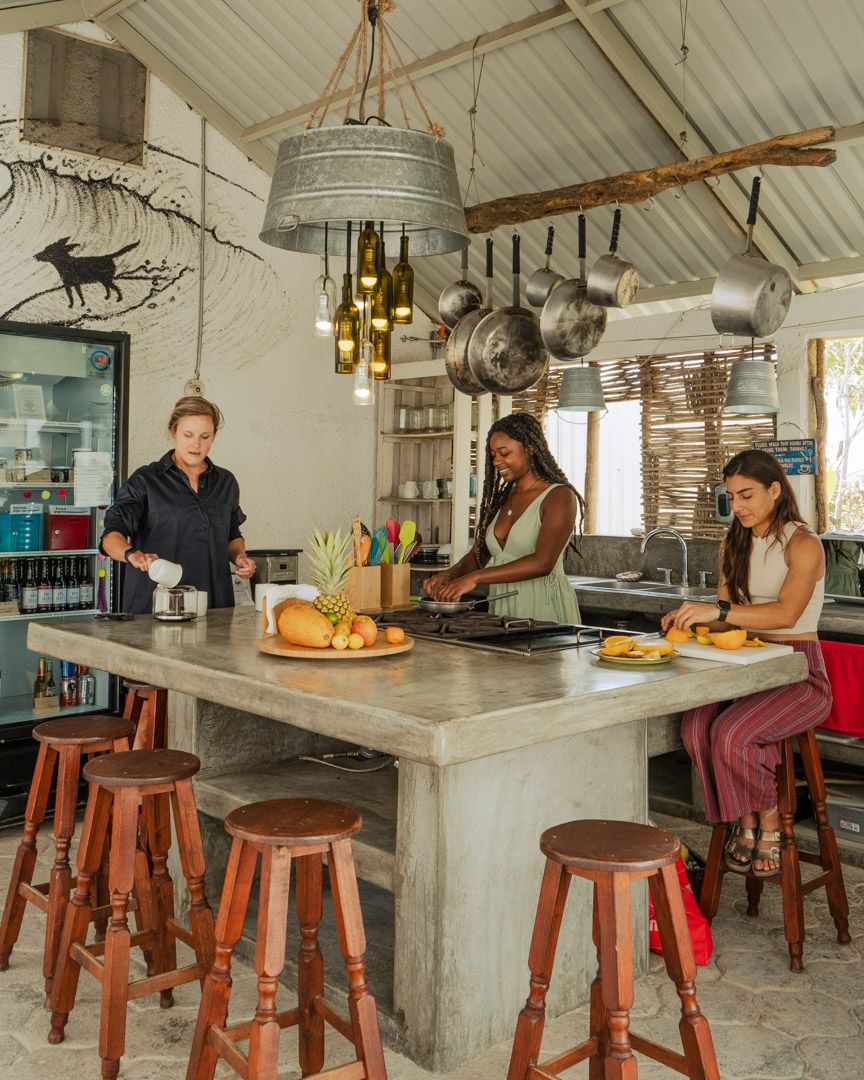 Members cooking and gathering at the communal kitchen island