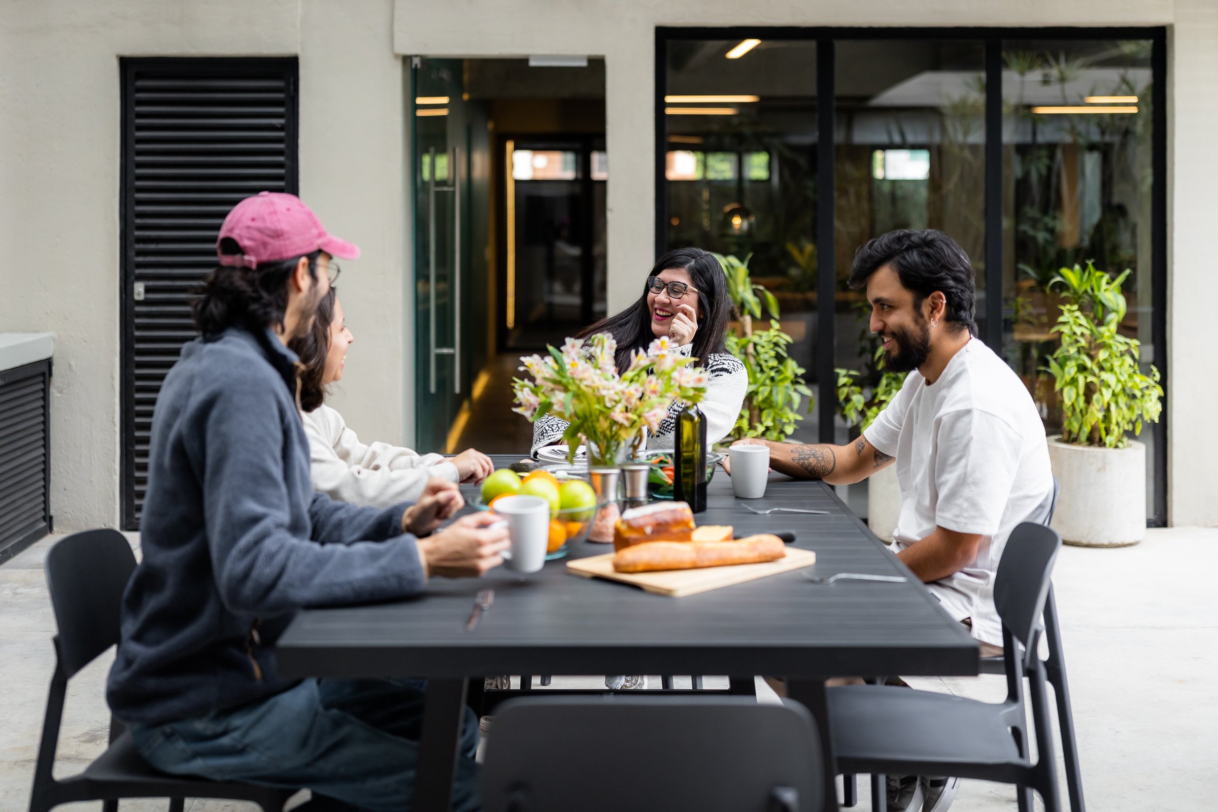 Members sharing a meal at the communal dining table
