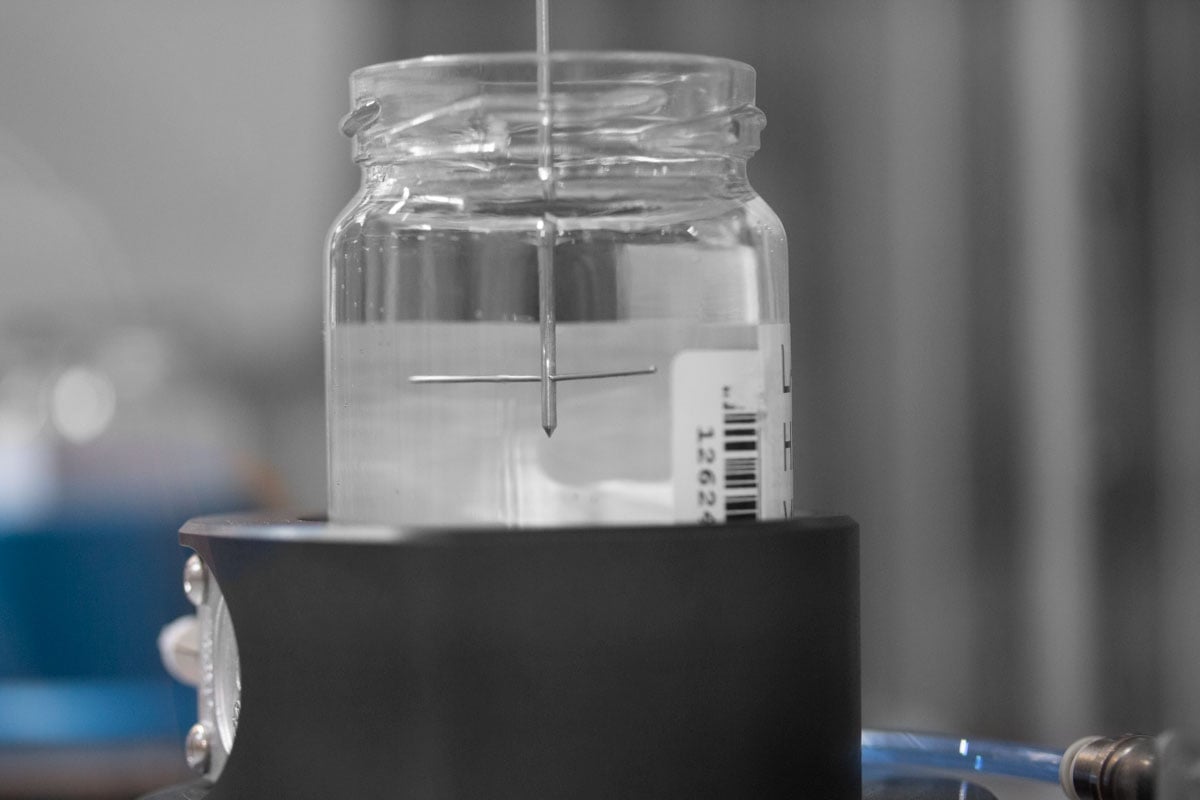 Close-up of viscometer performing a measurement in a vial