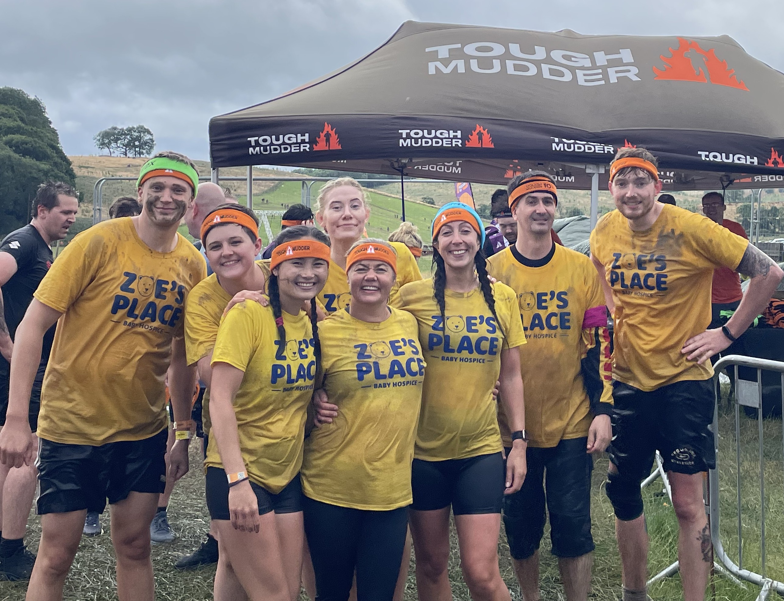 A group of Labman Tough Mudders at the finish line looking very muddy