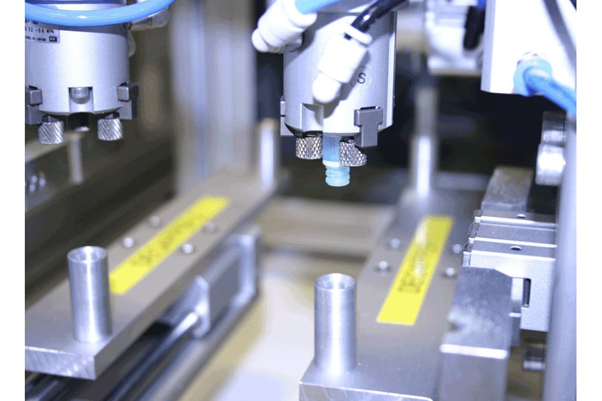 a robotic system performing a decapping of a vial 