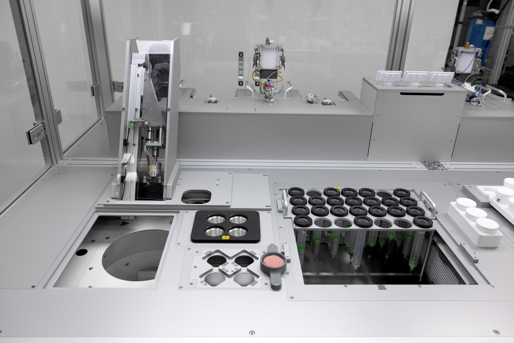 A formulation system with DAC mixer, heating and sonication baths and a rack of syringes