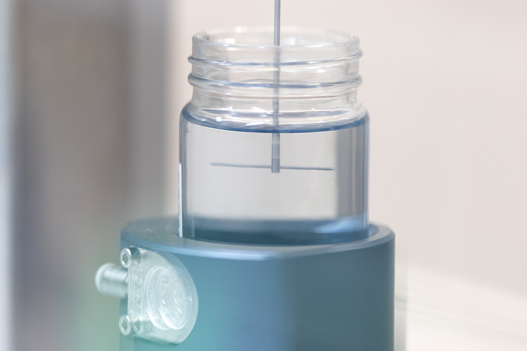 A T-bar geometry entering a jar of clear whilst liquid taking a viscometry measurement