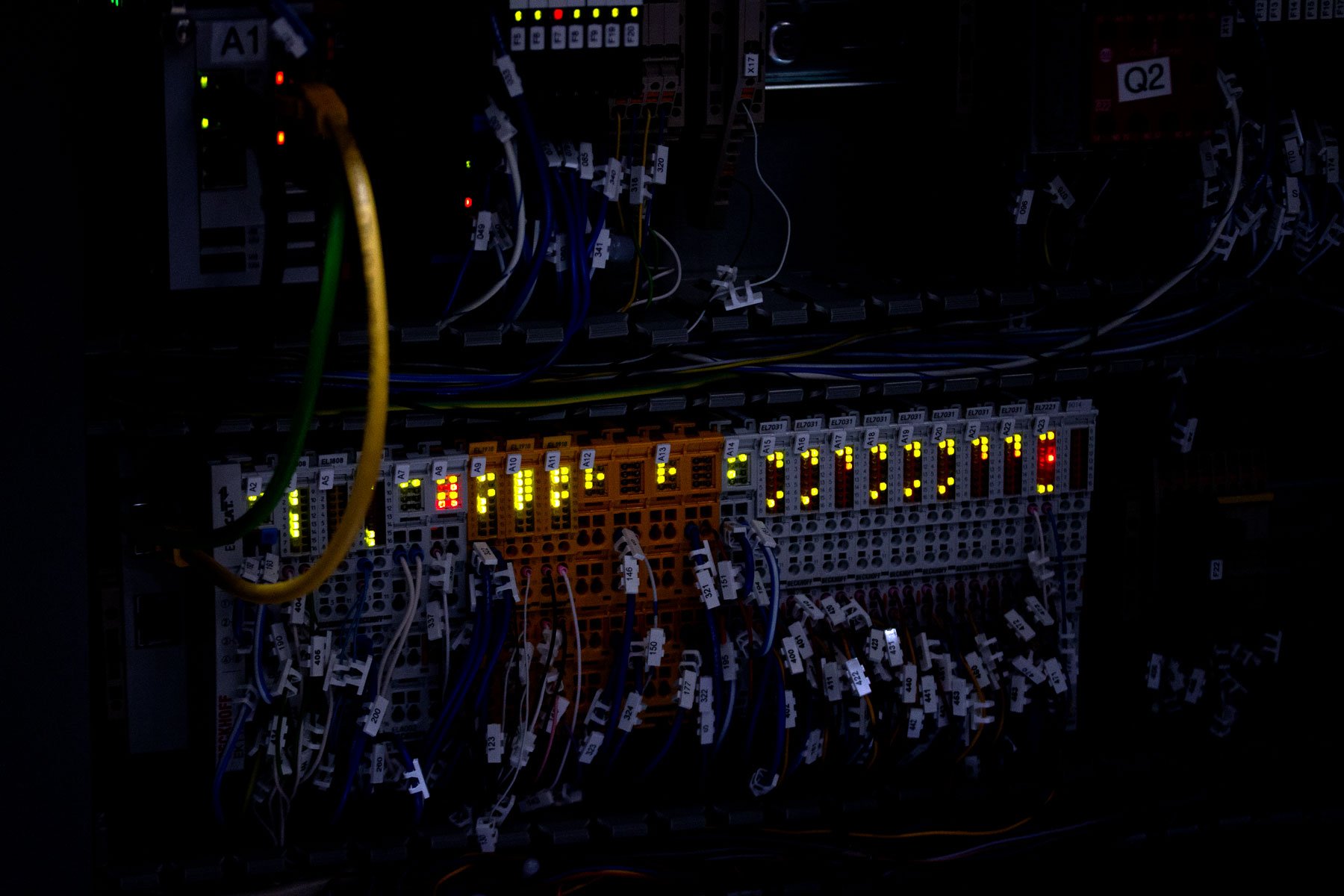 a circuit board in the dark with wires coming out of it