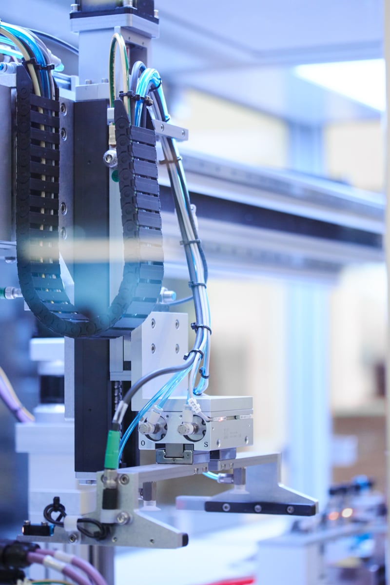 A close up of a silver and black automated dispenser robot 