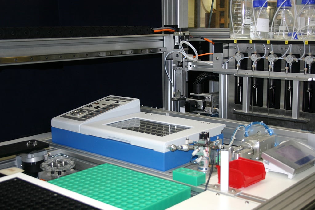 A labman custom robotic system with vial racks and liquid handling tubes 