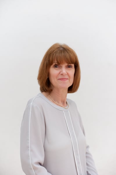 A headshot of a woman smiling on a white background