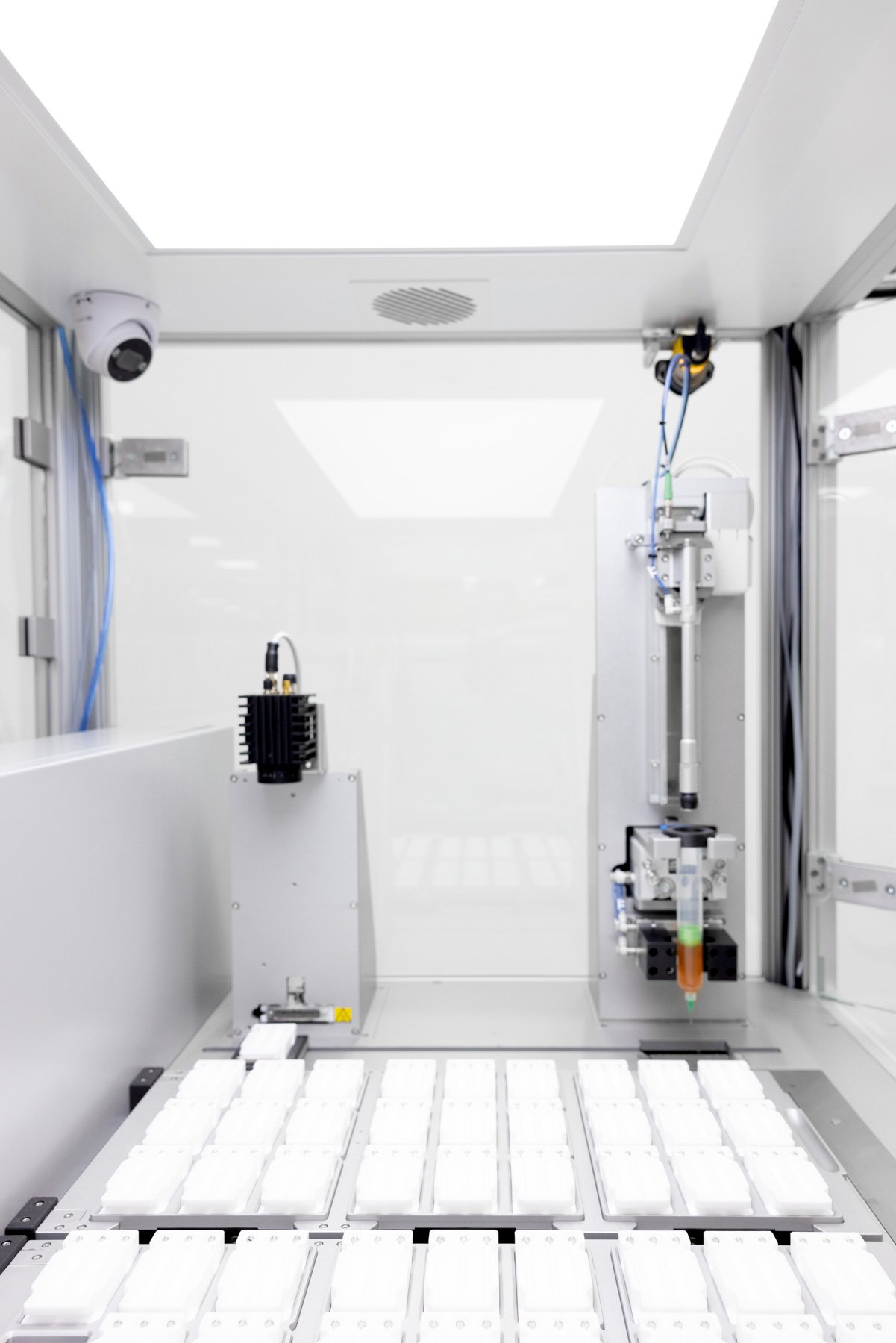 An automated polymerisation platform bed with racks of moulds