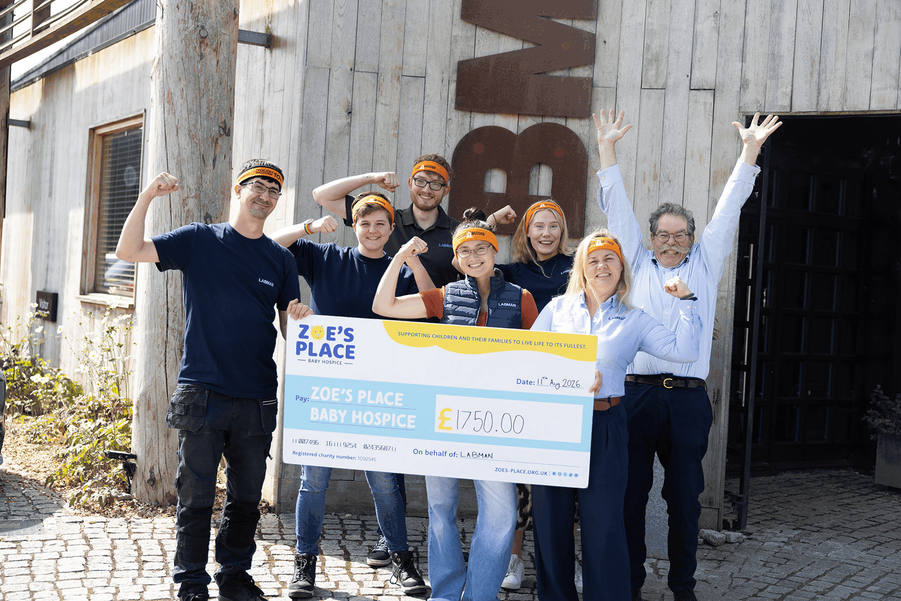 Tough Mudder fundraisers with Zoe's Place cheque
