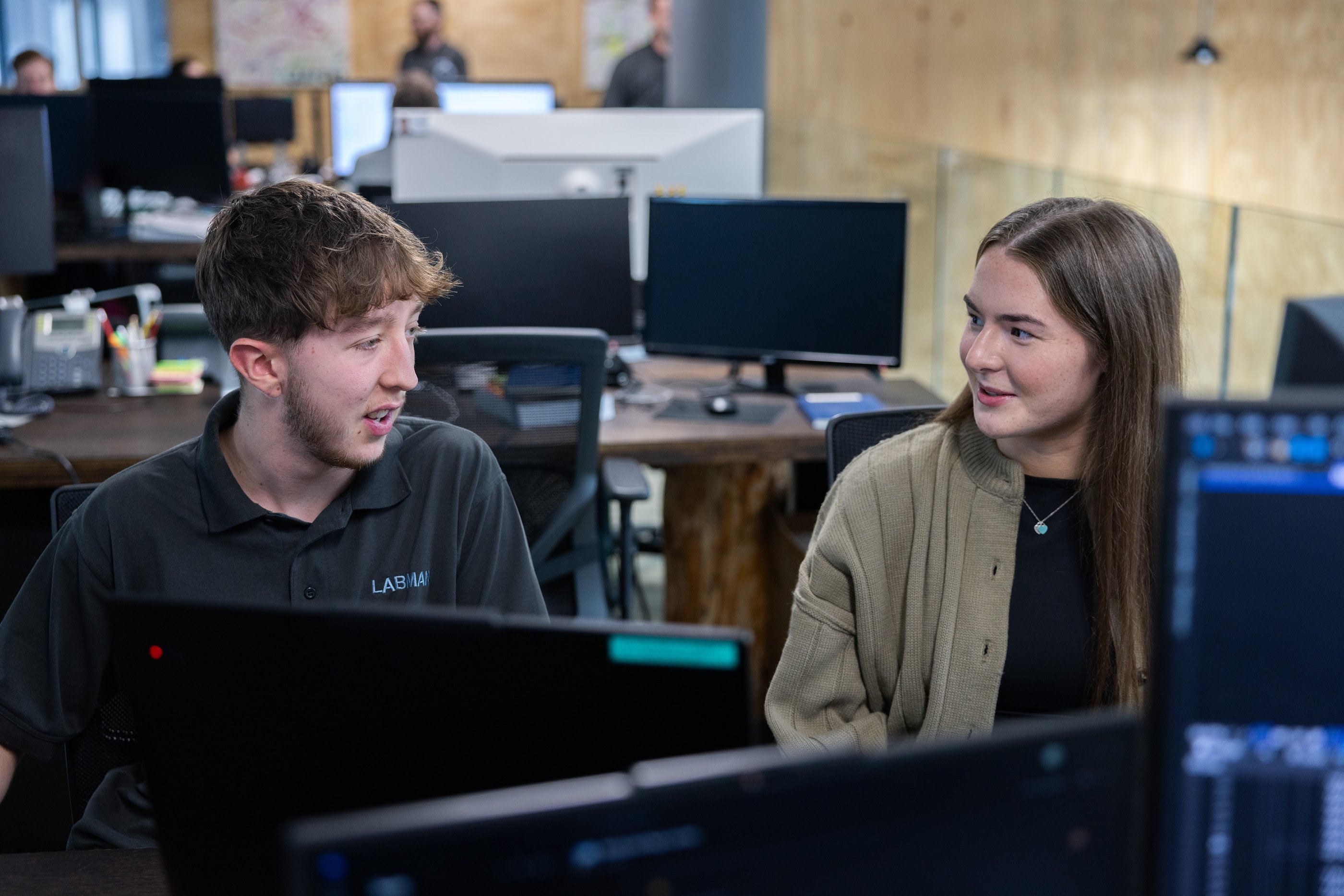 Two people in an office having a casual converation