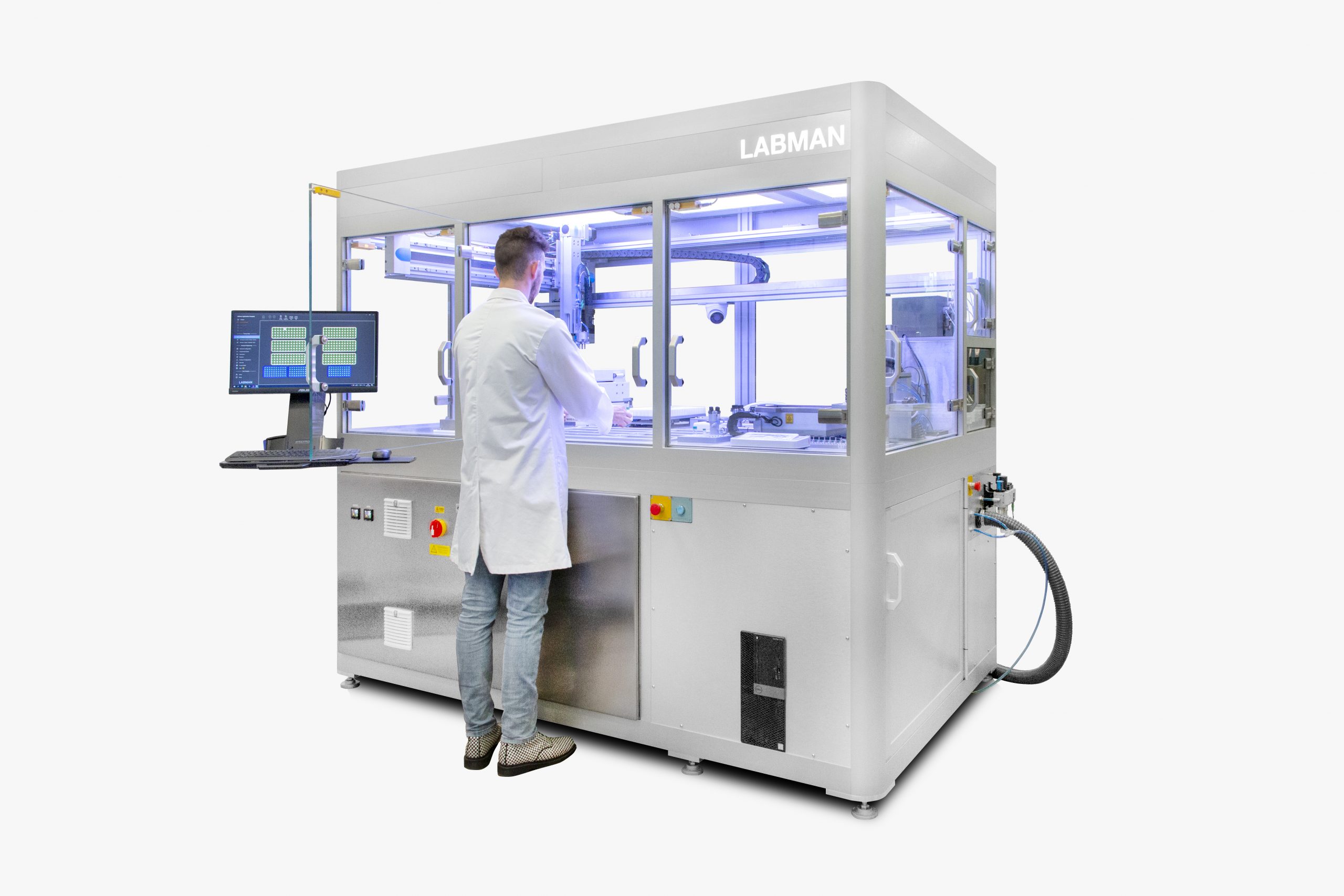 A man in a white lab looking down at a labman robotic system in a white room