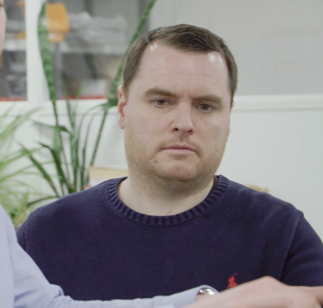 A man's face, listening intently