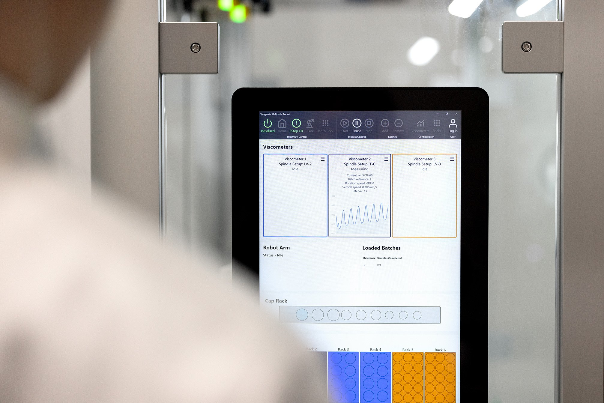 A user interacting with an interface on a robotic system in a lab setting