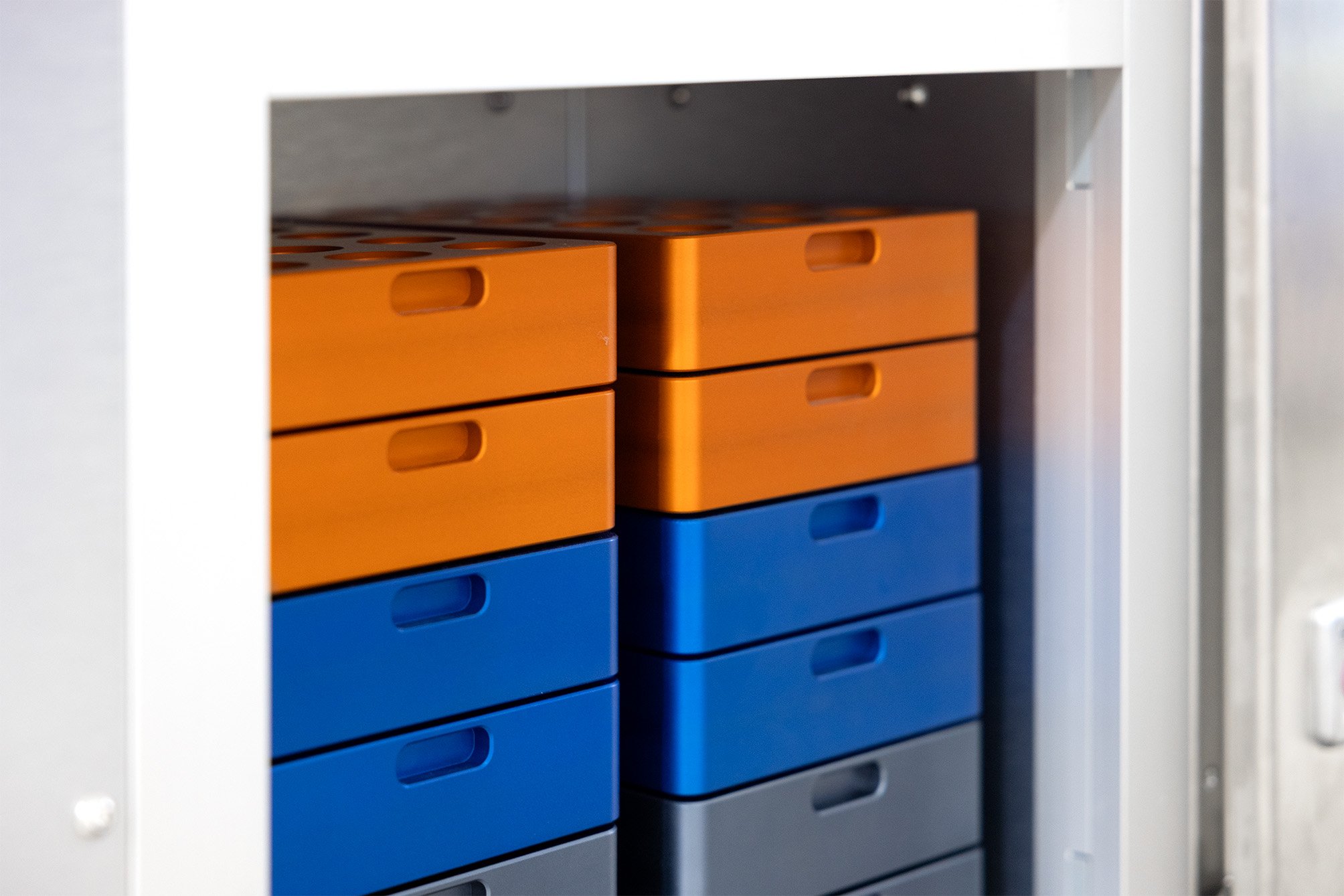 Metal racks for vials and jars, stacked in a robotic system