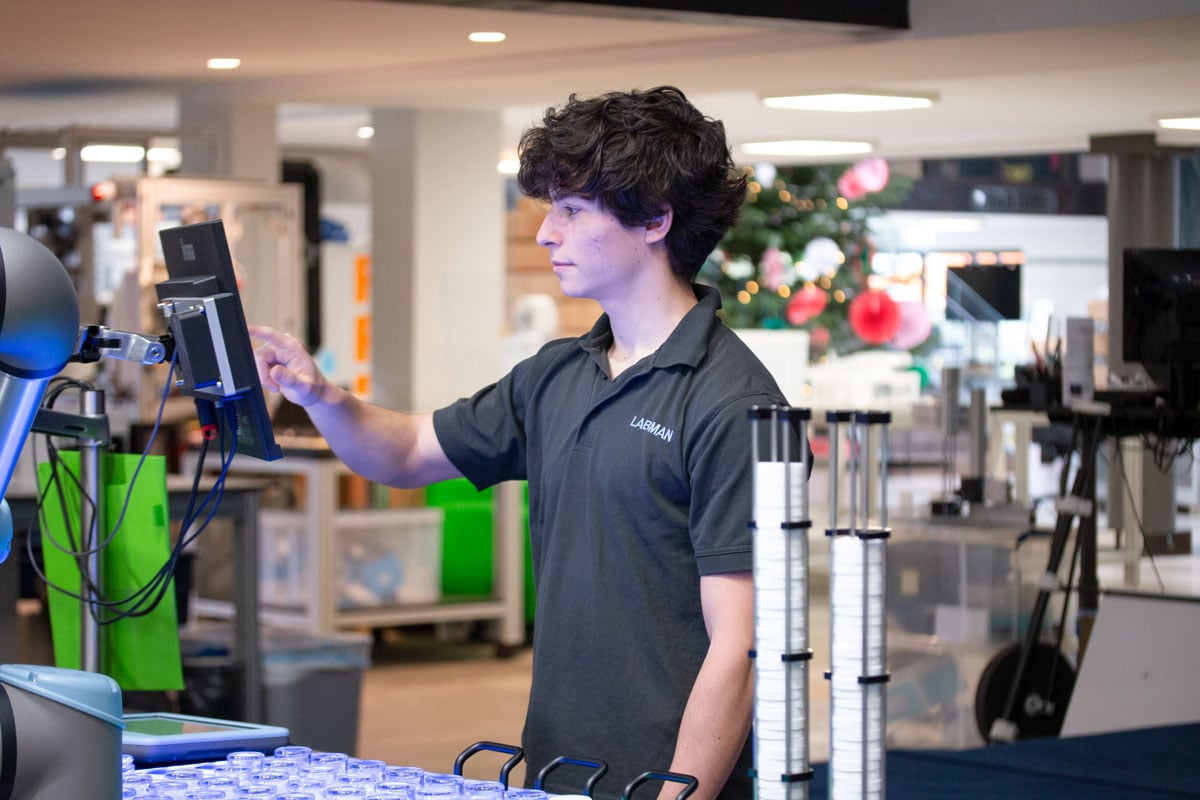 Intern Mario Labman polo shirt pressing touch screen