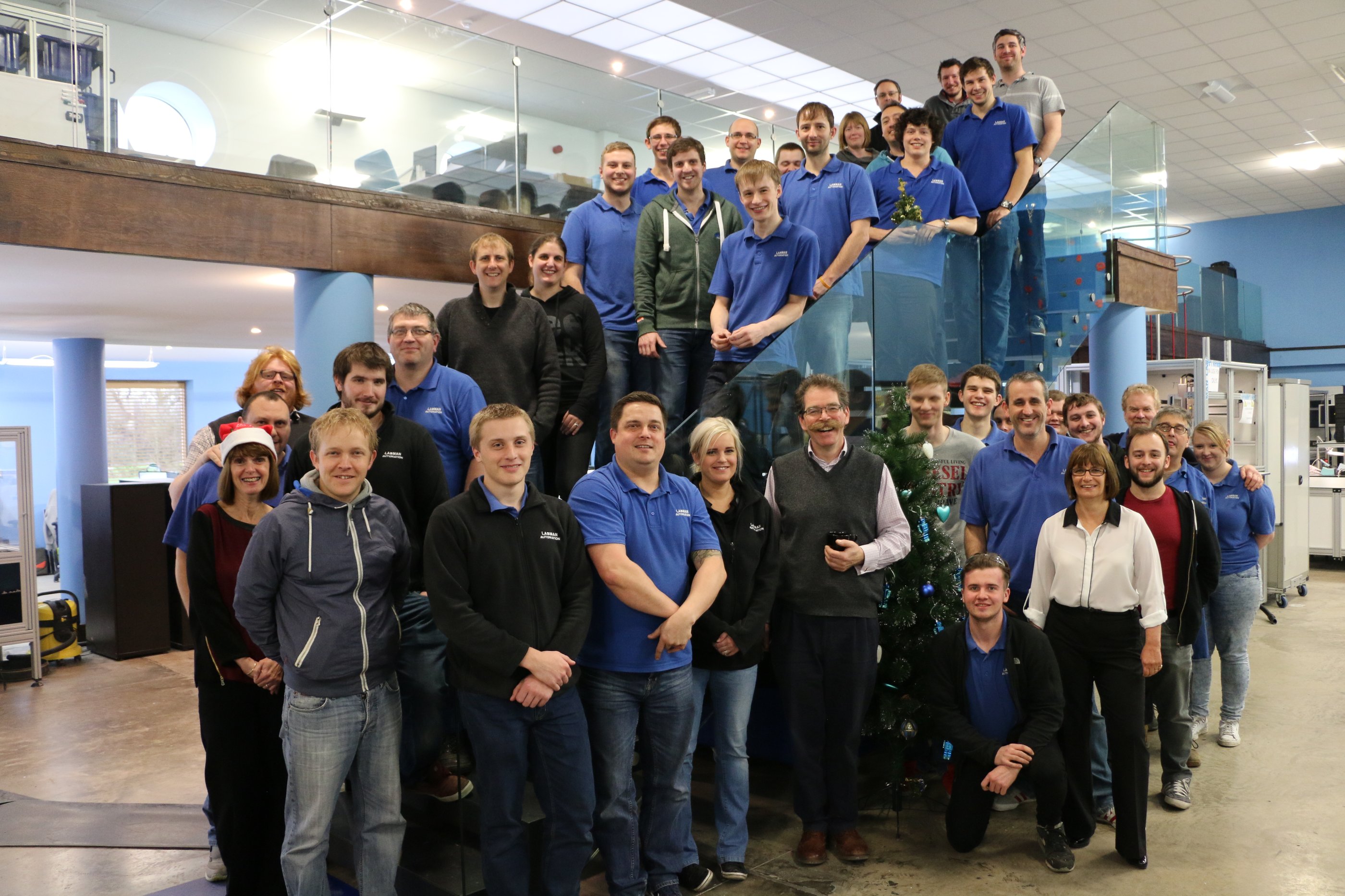 A group of Labman staff standing in a building looking towards the camera