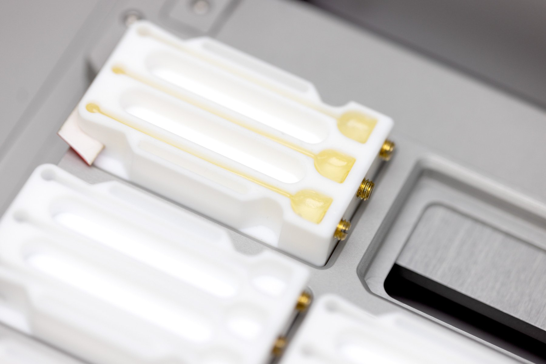 A yellow resin cured in a three channel mould, within a rack