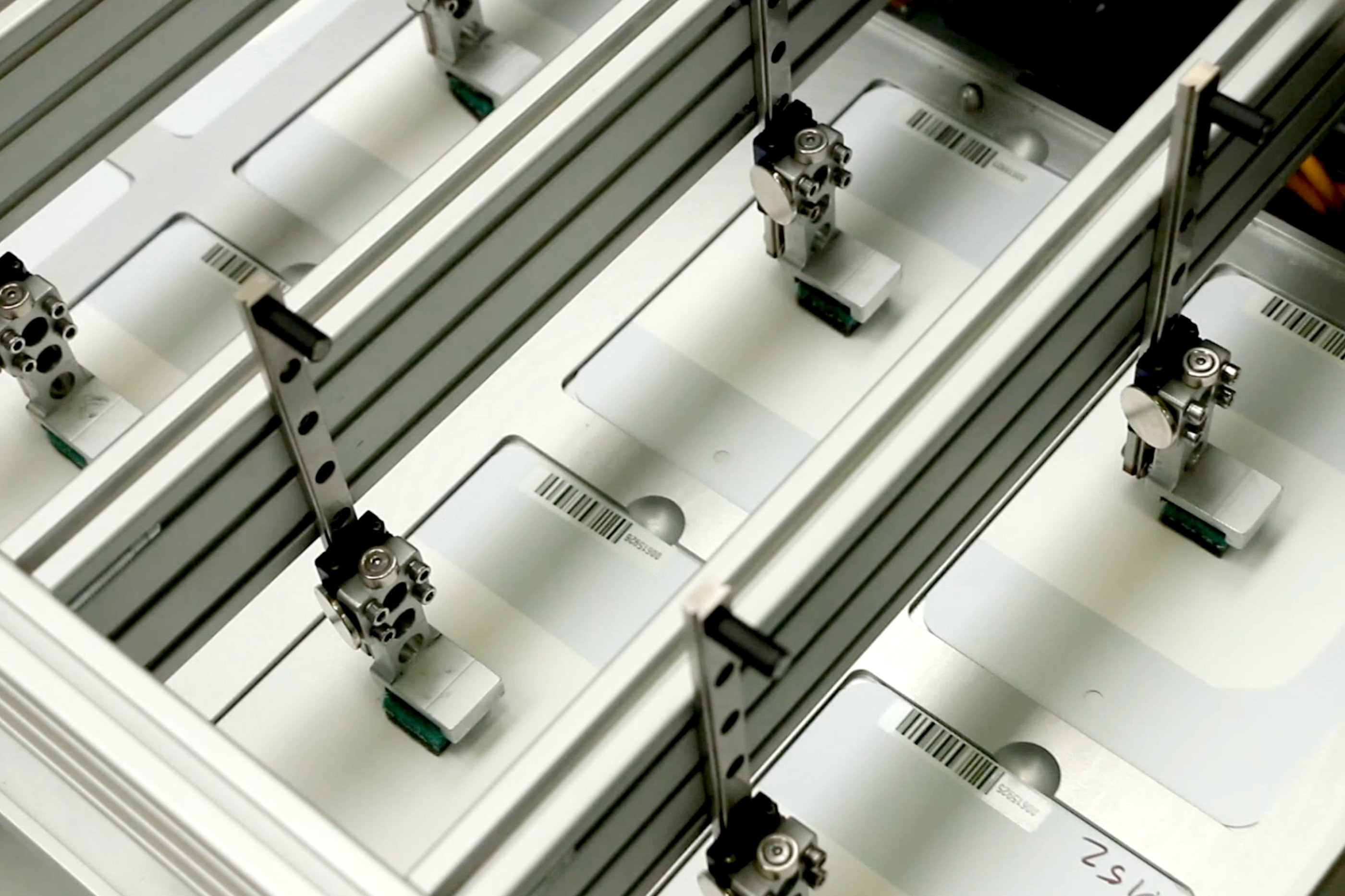 A robotic system scrubbing several paint panels 