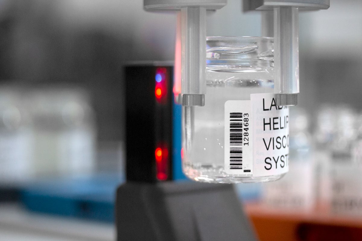 Sample jar being held by robot arm to built in barcode scanner