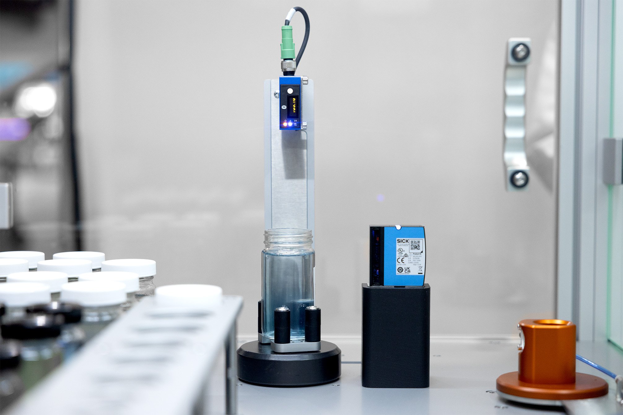 A barcode reader and decapping station within a robotic system