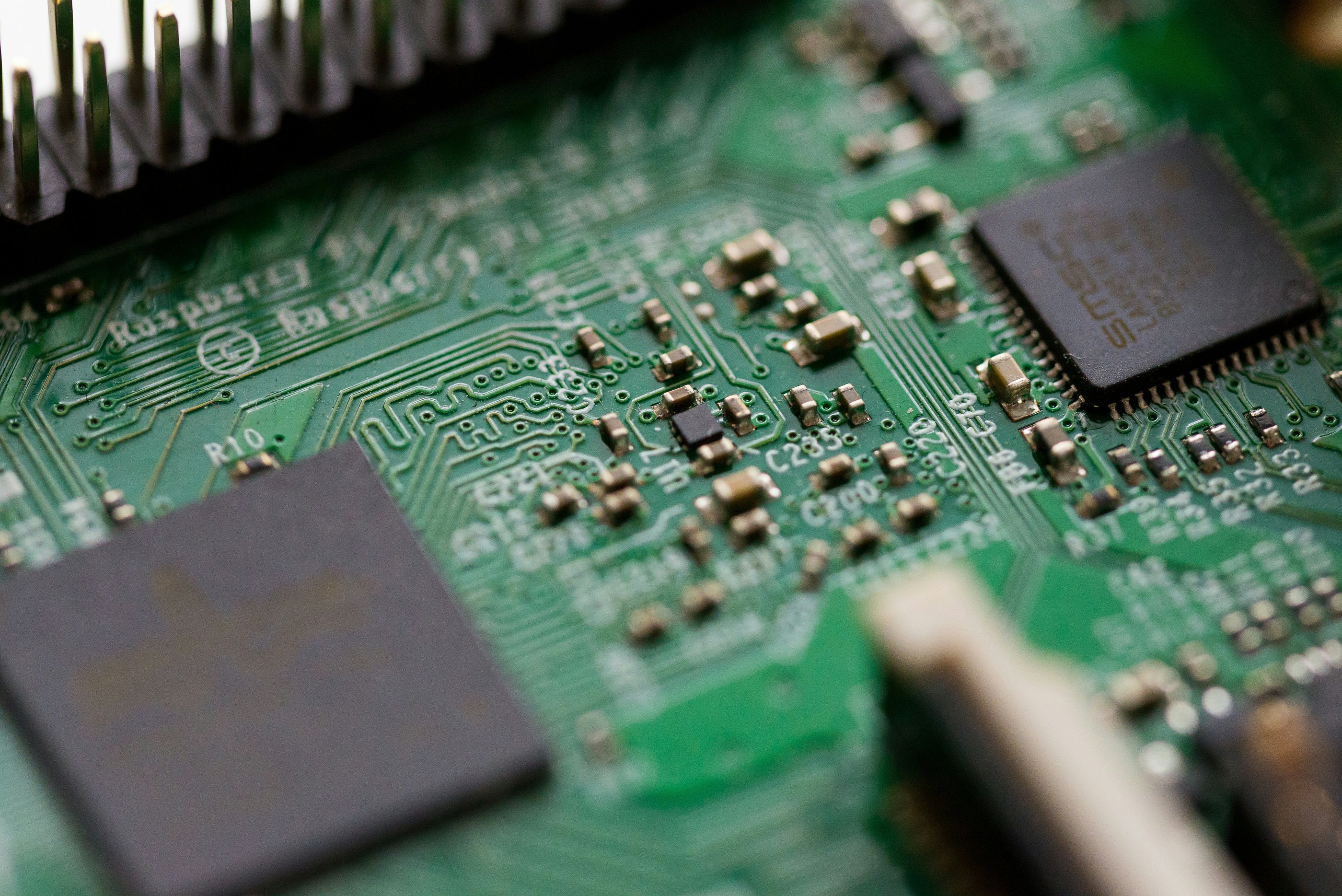 A close up of a green electrical circuit board