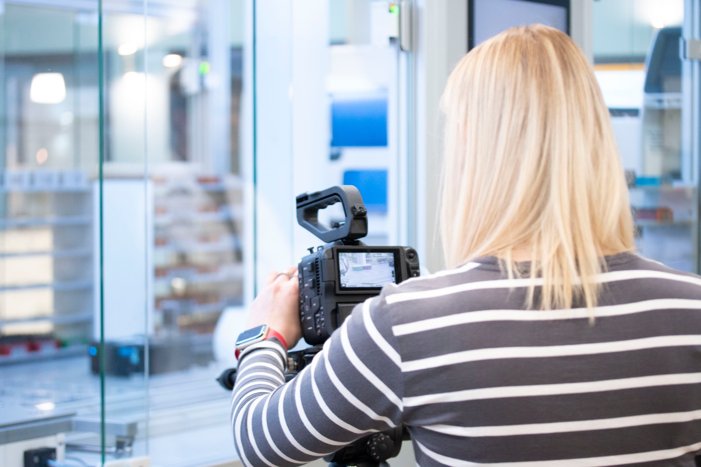 Marketing taking a picture of a robot with a camera