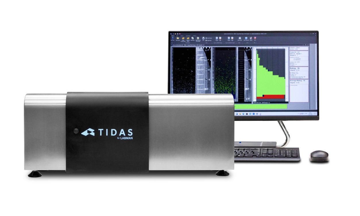 A Labman TIDAS metal box with the tidas logo on the front of a dark matt black metal cover in the background is a computer showing a graph
