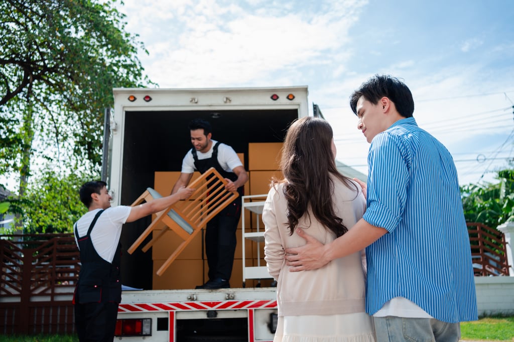 Moving to Agoura Hills: Couple Overseeing Movers Unloading Furniture