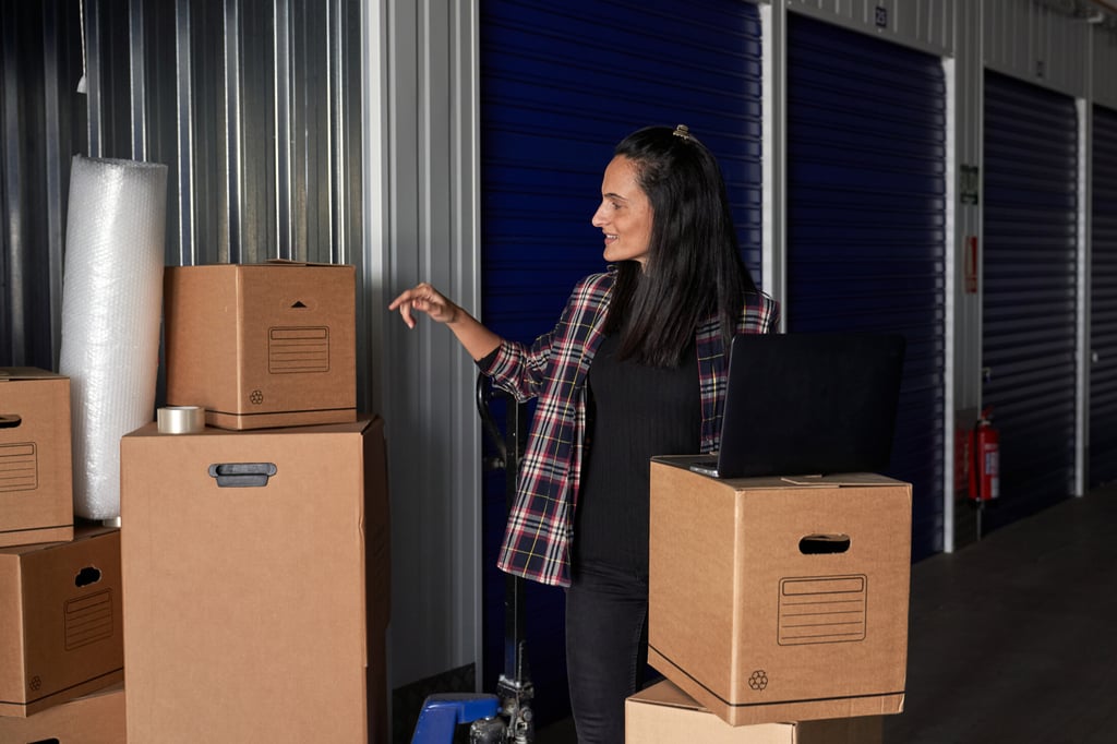 Woman overseeing packed boxes in storage unit provided by OverEasyMovers in Agoura Hills.