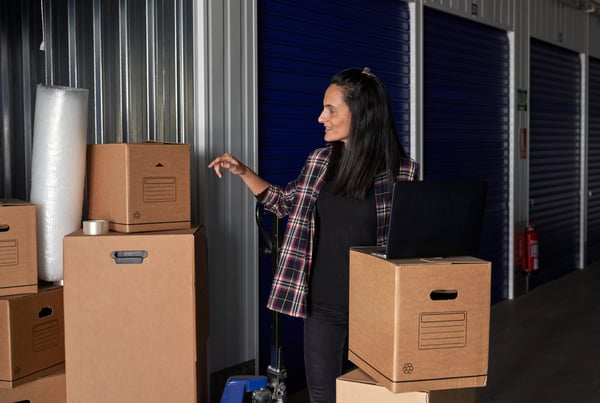 Woman overseeing packed boxes in storage unit provided by OverEasyMovers in Agoura Hills.