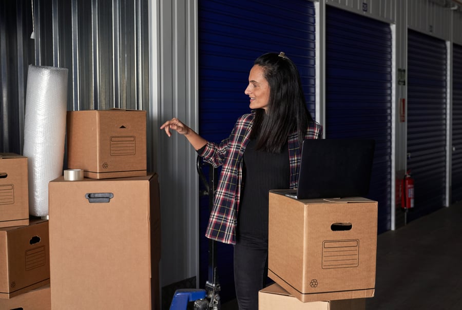 Packing Services 6 Woman overseeing packed boxes in storage unit provided by OverEasyMovers in Agoura Hills.
