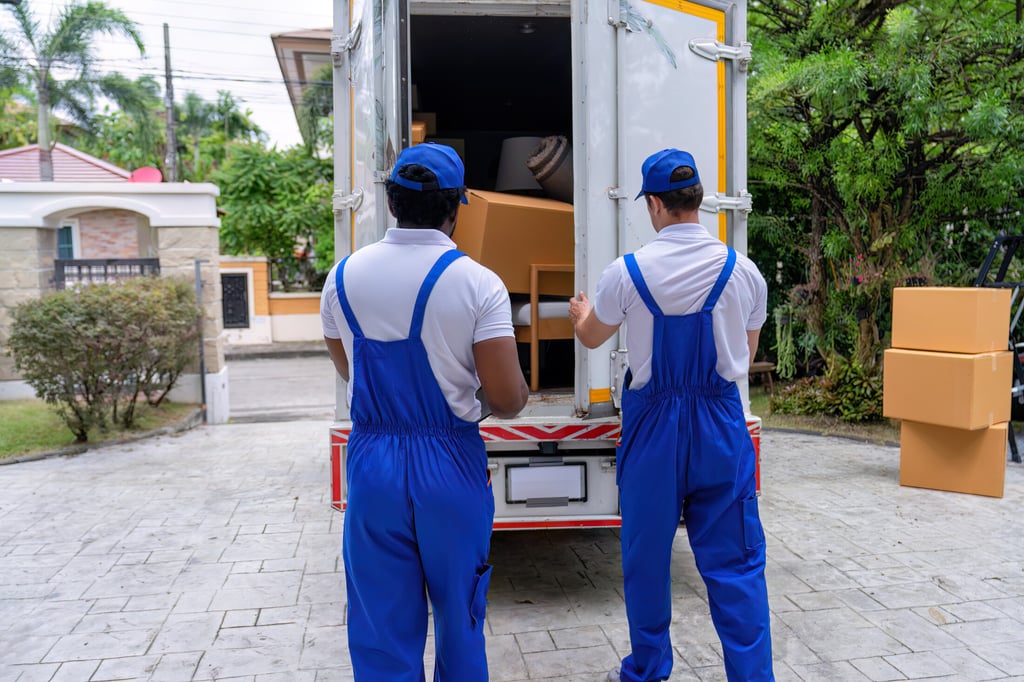 Movers loading furniture into a truck for OverEasyMovers in Alhambra