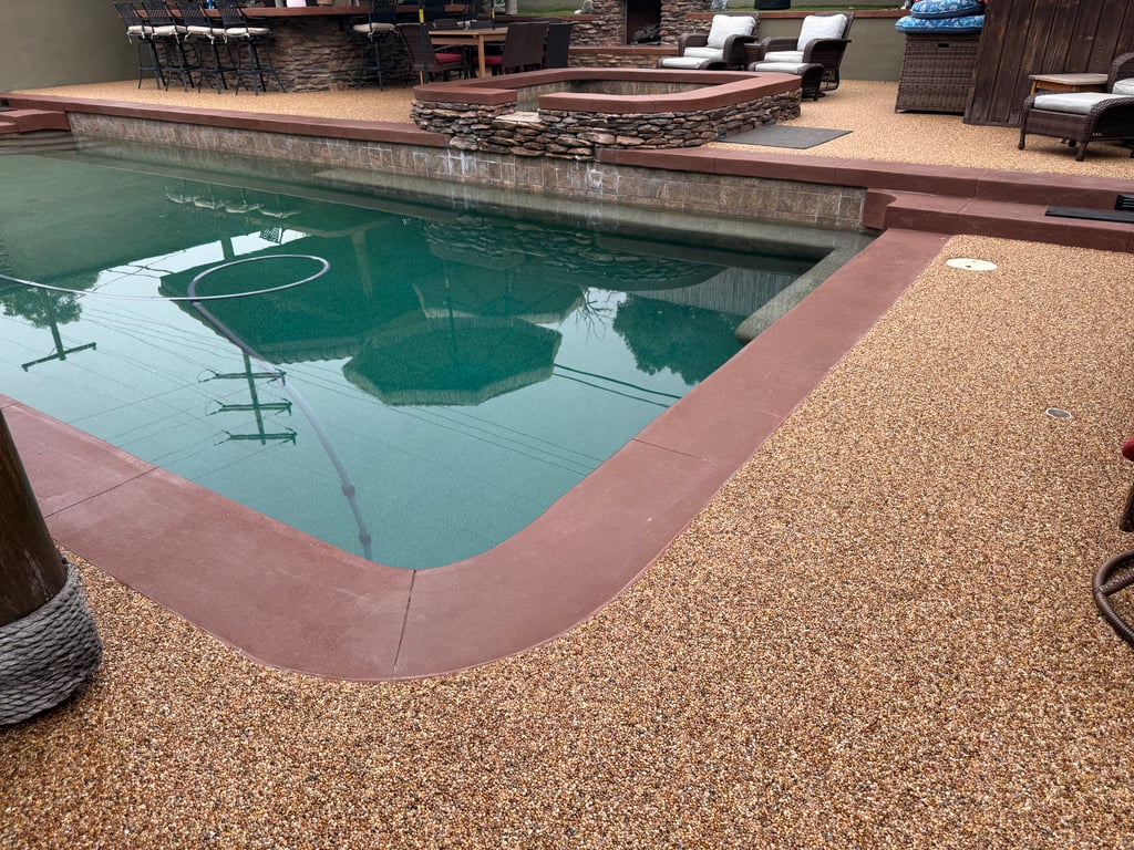 Stone Carpet Pool Deck – Safe, Stylish & Slip-Resistant Overlay Pool deck resurfaced with epoxy stone carpet overlay, featuring natural river pebbles and UV-stable resin for a slip-resistant, cooler surface.