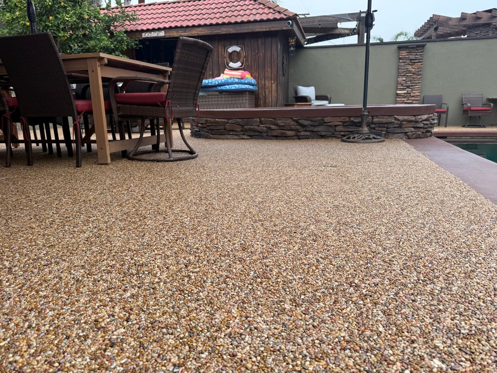 Pebble Epoxy Stone Carpet Patio – Durable & Elegant Outdoor Flooring Outdoor patio with pebble epoxy stone carpet flooring by Stone Carpet Pros, featuring natural river pebbles and UV-stable epoxy for a durable, slip-resistant surface.