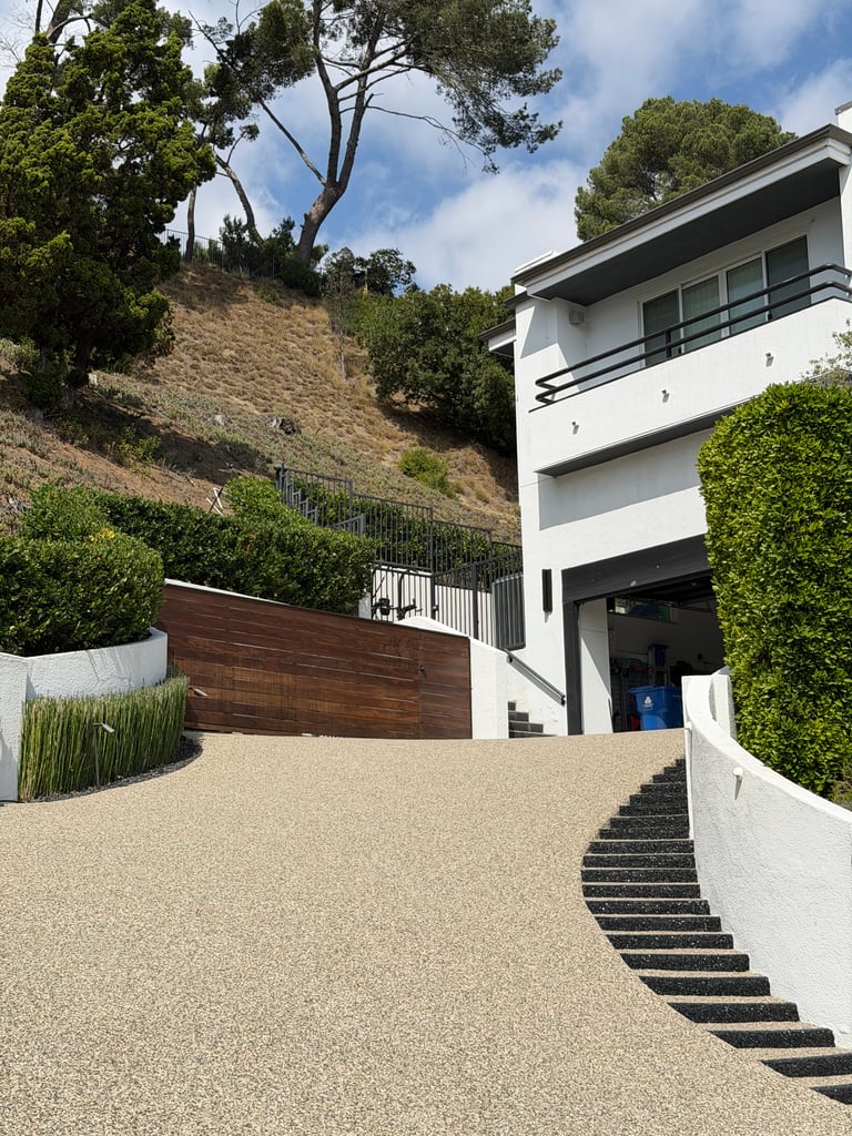 driveway_resurfacing_with_decorative_pebble_epoxy_stonecarpetpros-10-01-2025-1 Residential driveway resurfaced with pebble epoxy overlay in Southern California, showing natural stone texture and seamless finish.