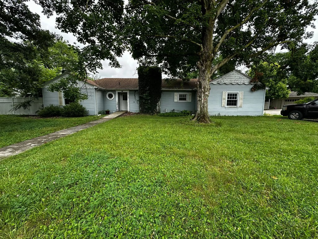 Exterior of a damaged Indiana home sold as-is for cash to Spectrum Property Solutions.