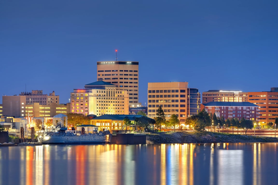 Downtown Evansville riverfront skyline representing Spectrum Property Solutions, local cash home buyers helping homeowners sell houses fast in Evansville, Indiana.