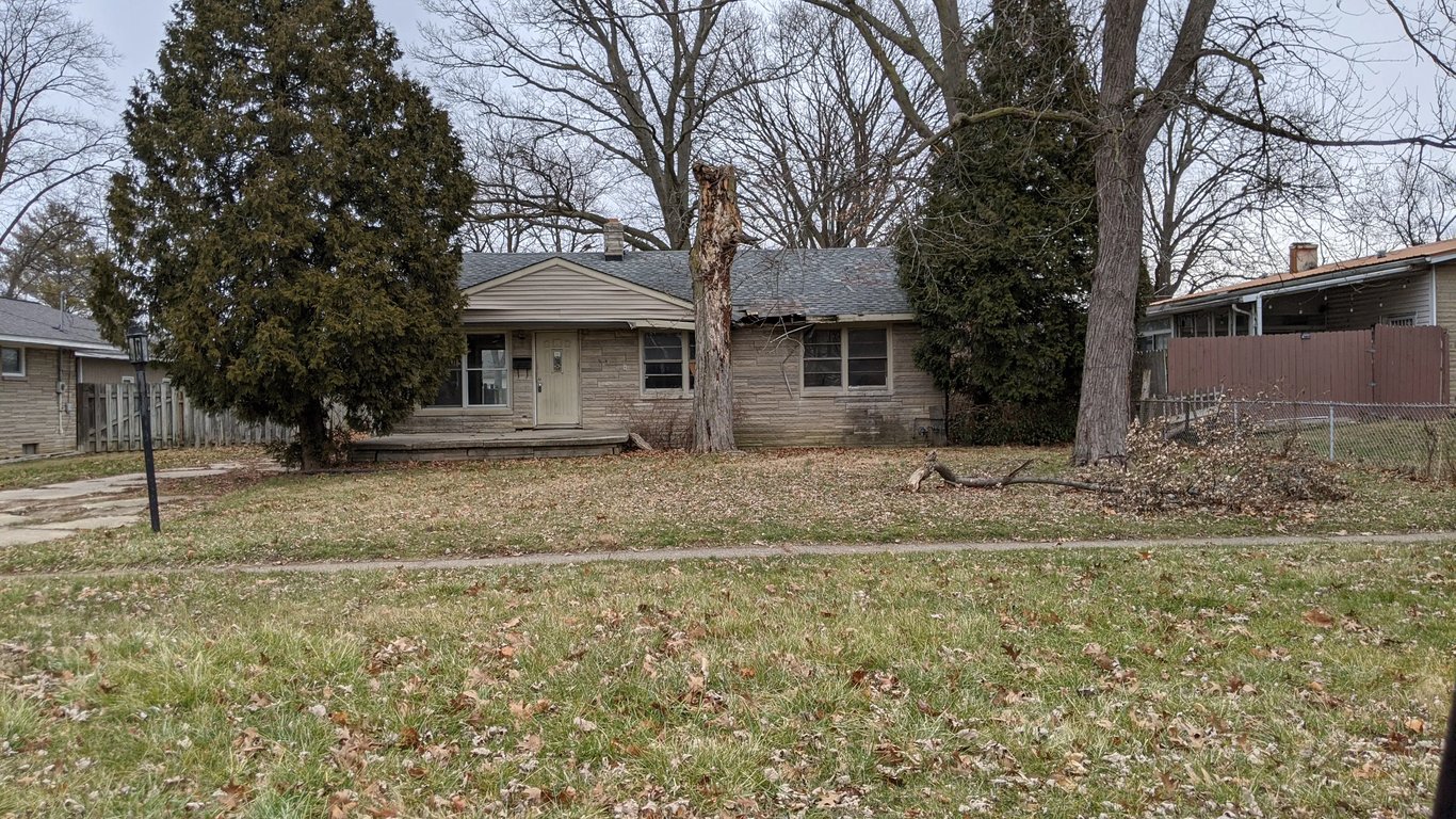 Abandoned Lafayette home with severe roof hole, water damage, and collapsed basement wall purchased by Spectrum Property Solutions